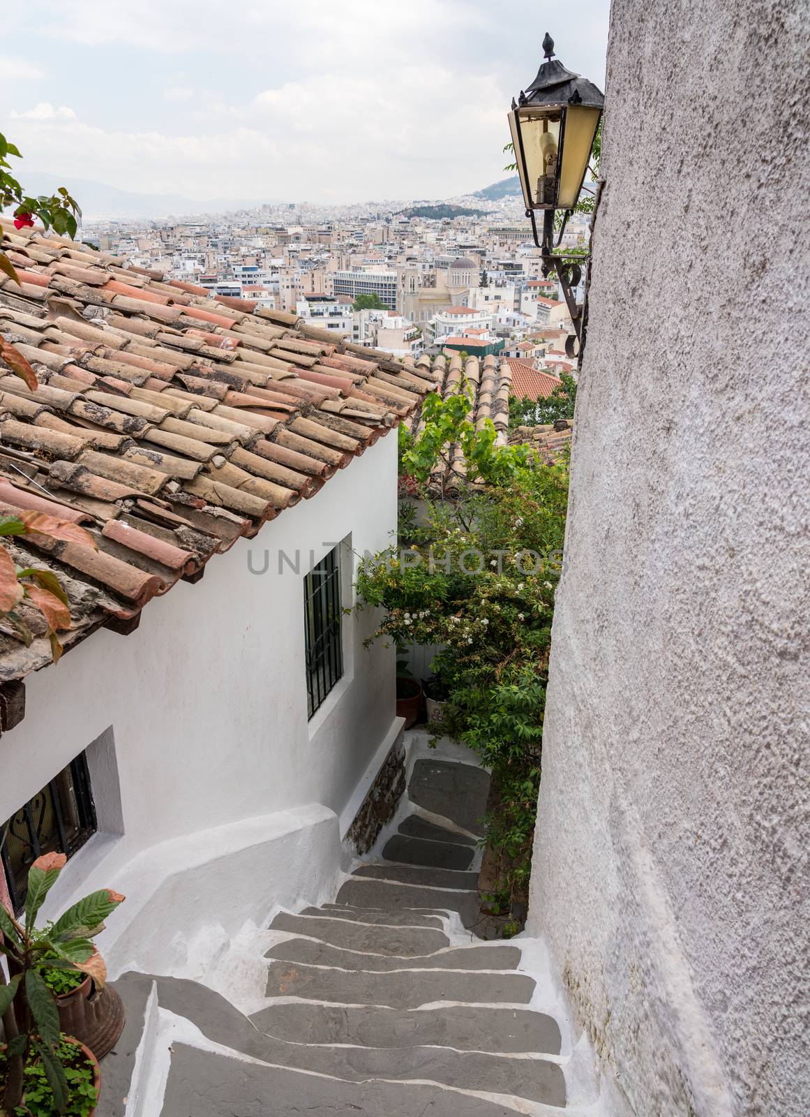 Narrow street in ancient residential district of Anafiotika in Athens Greece by steheap