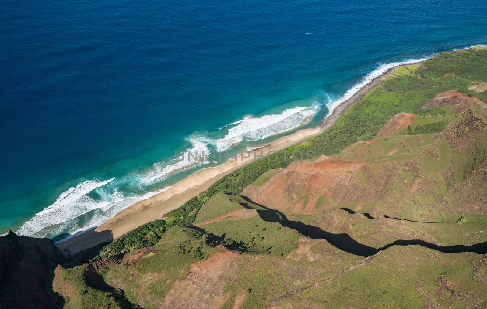 Aerial view of Na Pali coastline and Kalalau beach on hawaiian island of Kauai from helicopter flight