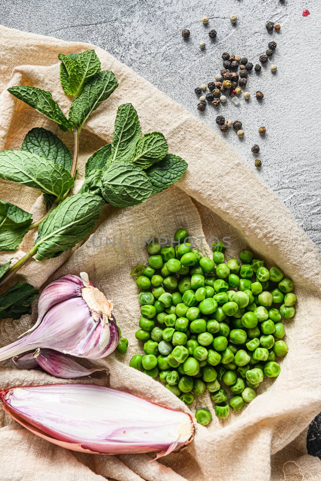 British mushy peas organic ingredients peas mint shallot pepper and salt keto food overhead photo over grey stone background and cloth top view vertical by Ilianesolenyi