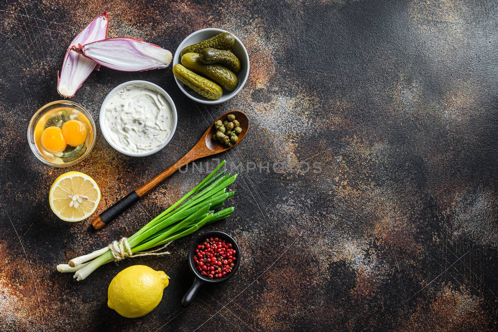 Ingredient tartar sauce organic mayonnaise, lemon,capers,parsley,dill,onion and various herbs. Over old rustic metall background Top view space for text .