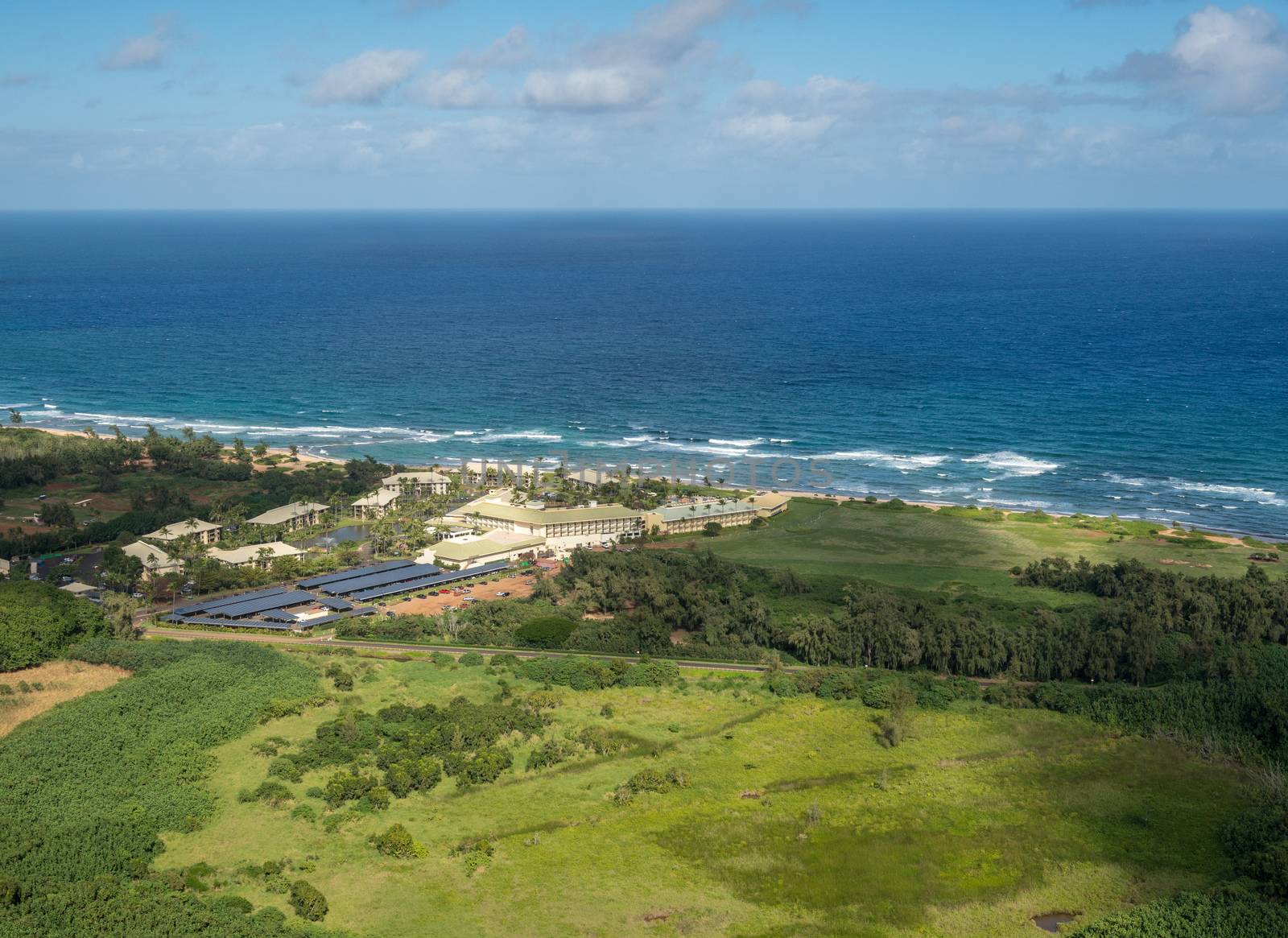 Aerial view of hotel and landscape of hawaiian island of Kauai from helicopter flight