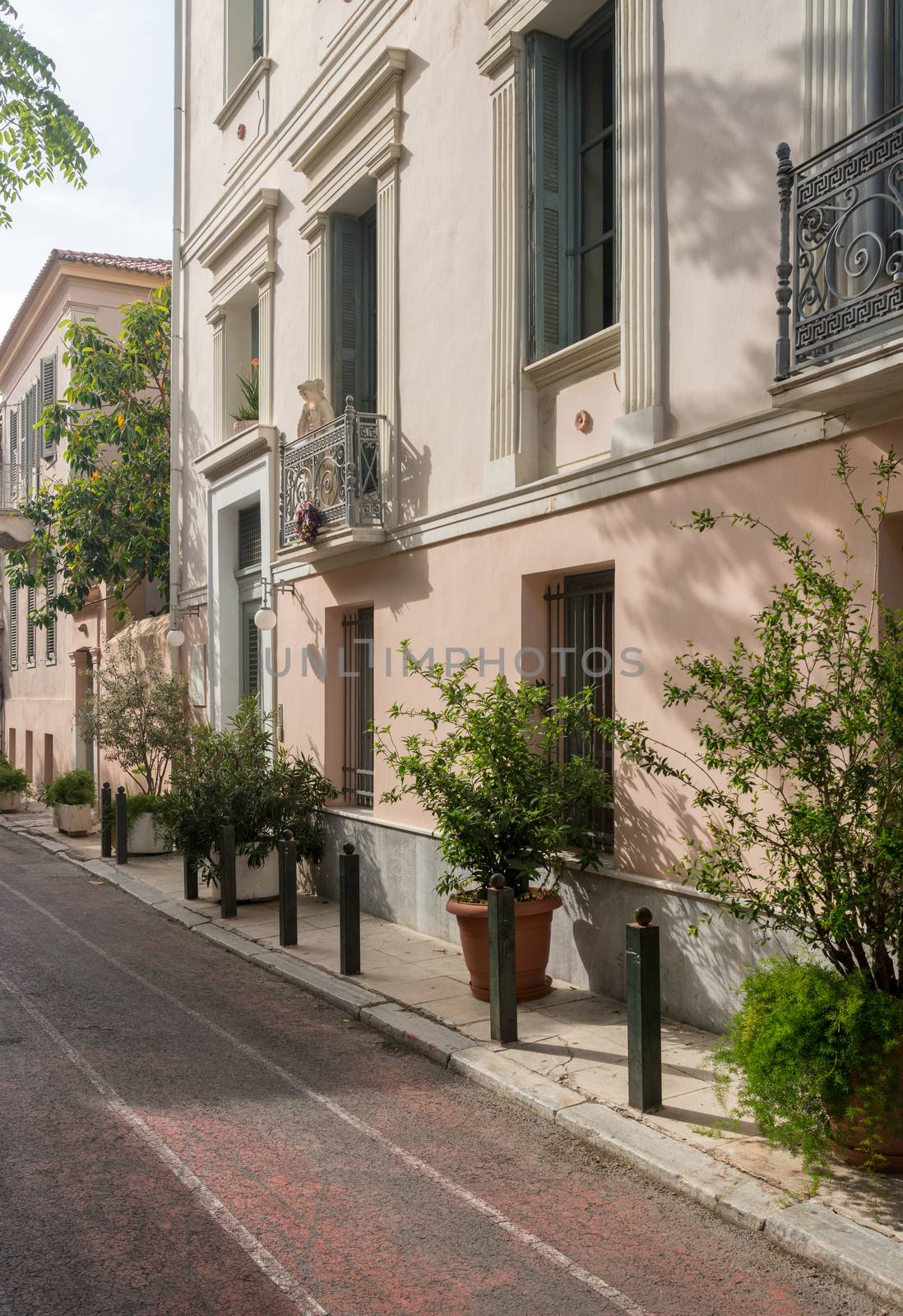 Statue on a wrought iron balcony in ancient district or neighborhood of Plaka in Athens by the Acropolis