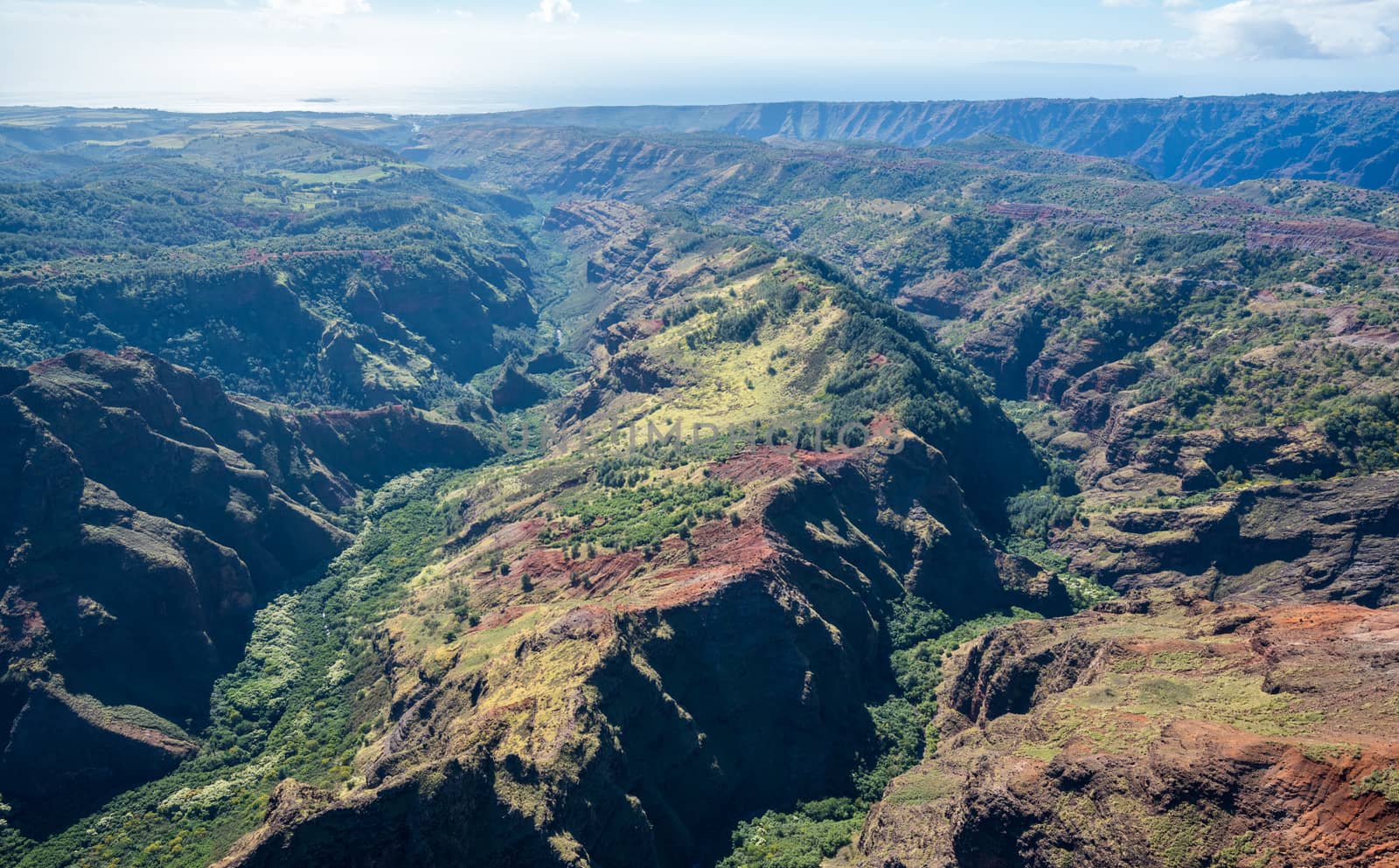 Aerial view of Waimea Canyon and landscape of hawaiian island of Kauai from helicopter flight