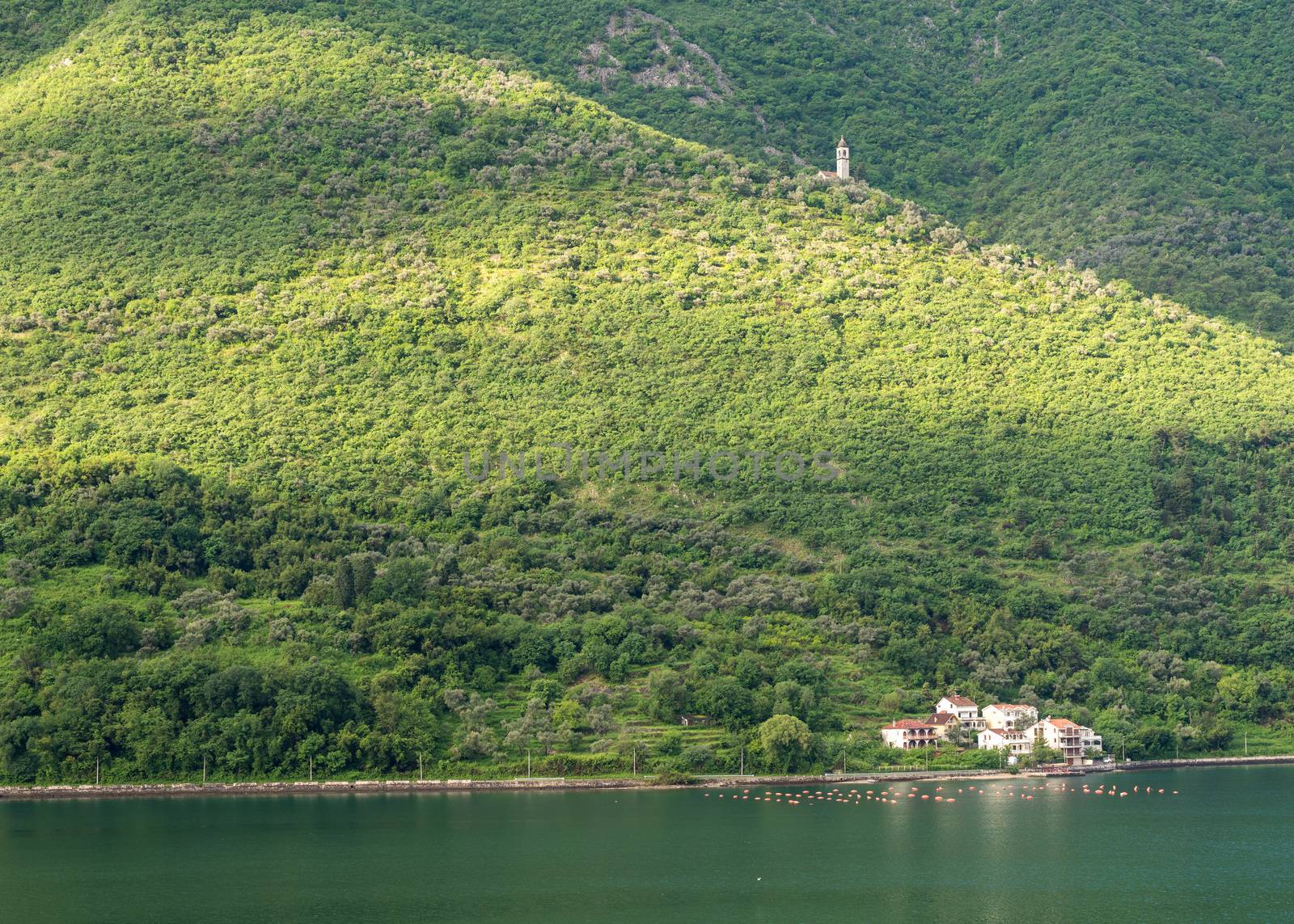 Small church on hillside of coastline of Gulf of Kotor in Montenegro