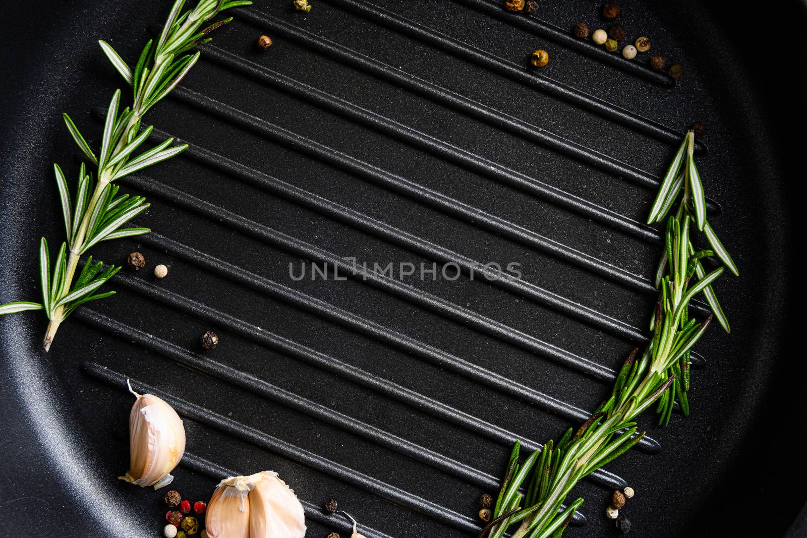 barbecue grill frying pan or skillet close up black with herbs for cooking top view concept for text or objects.