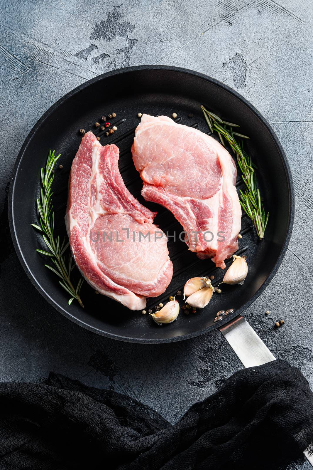 Pork belly Farm fresh in barbecue skillet with rosemary garlic pepper salt and black cloth linen top view dark background vertical by Ilianesolenyi
