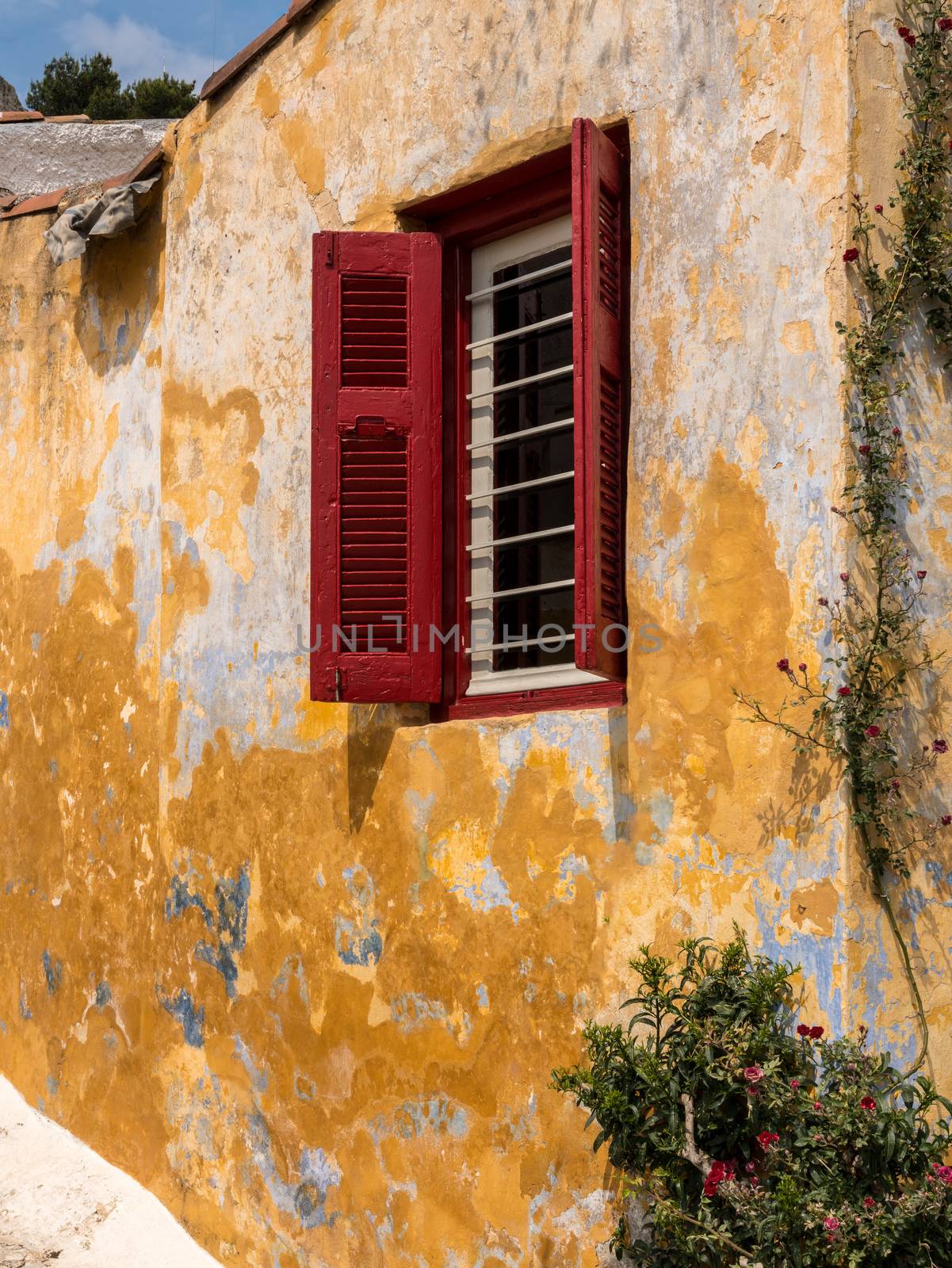 Red shutters on window in ancient district of Anafiotika in Athens Greece by steheap