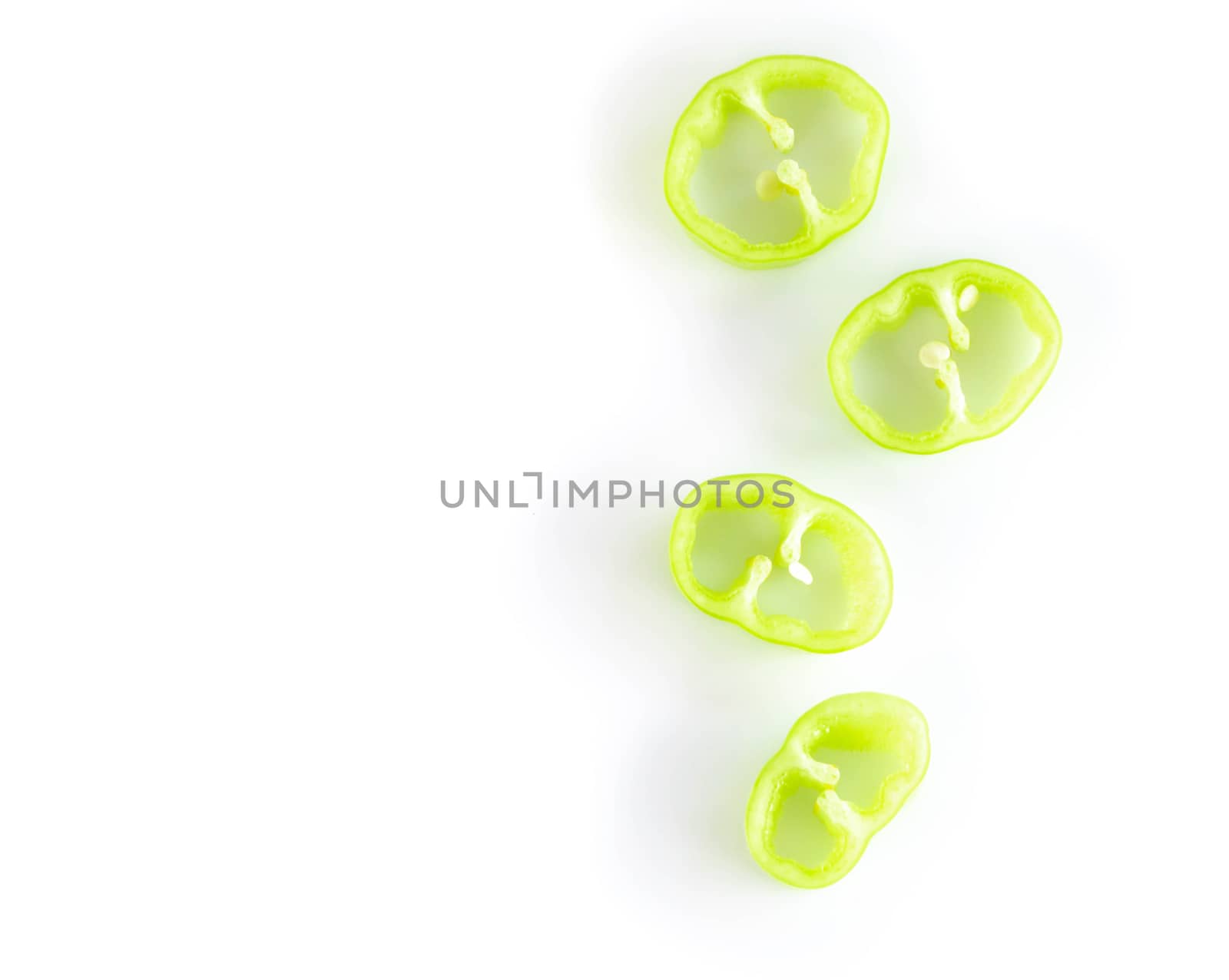 Closeup top view green chilli pepper sliced on white background, raw food ingredient concept