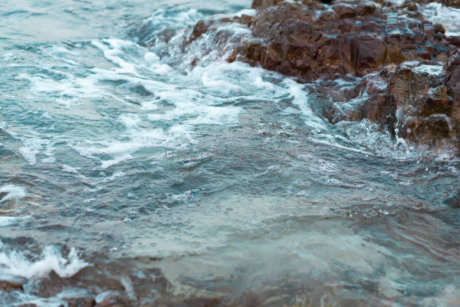 Sea wave breaking with rocky beach, Holiday and relax time concept, selective focus