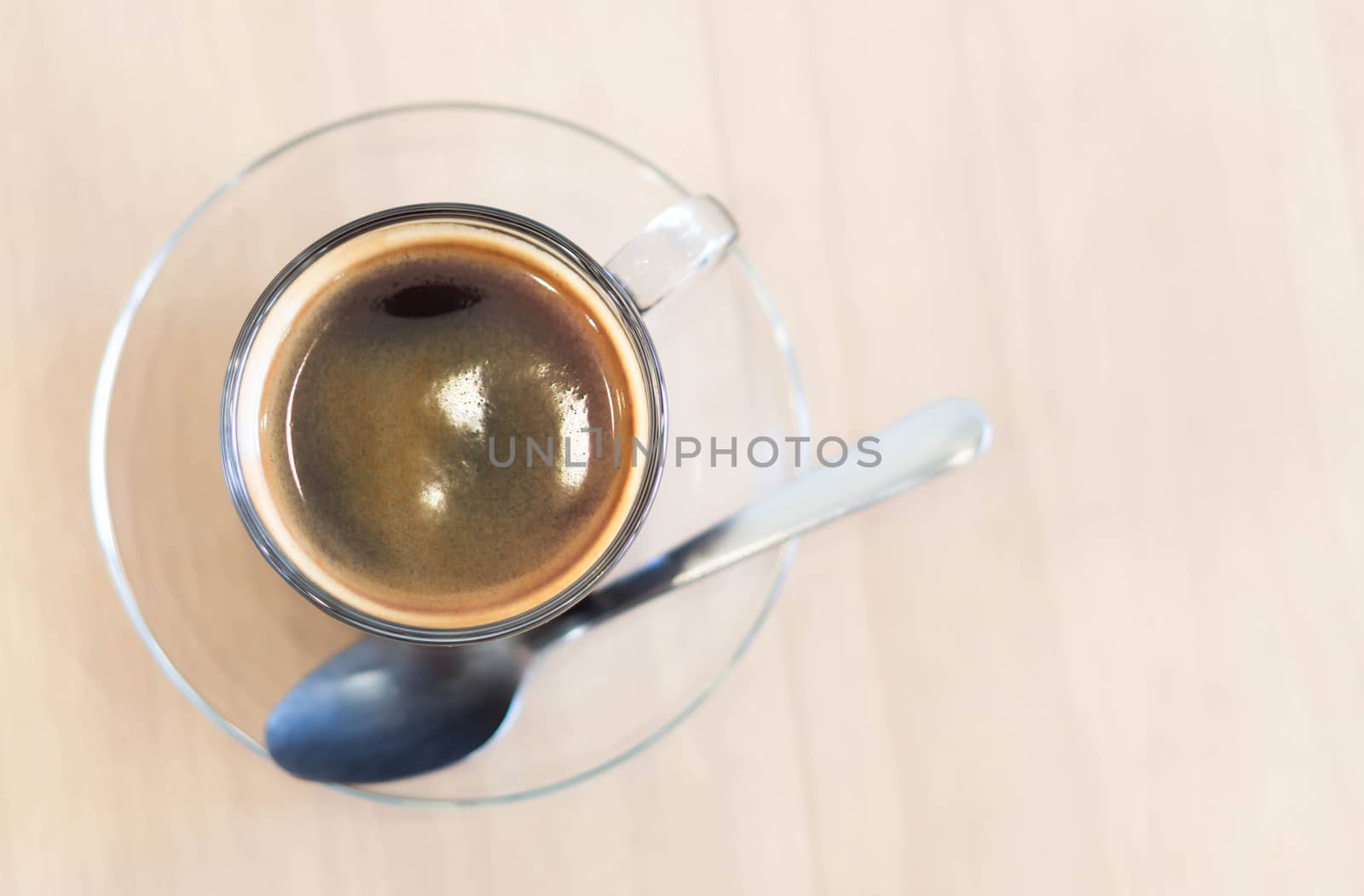 Closeup glass of hot americano coffee on wood table, selective focus, vintage tone