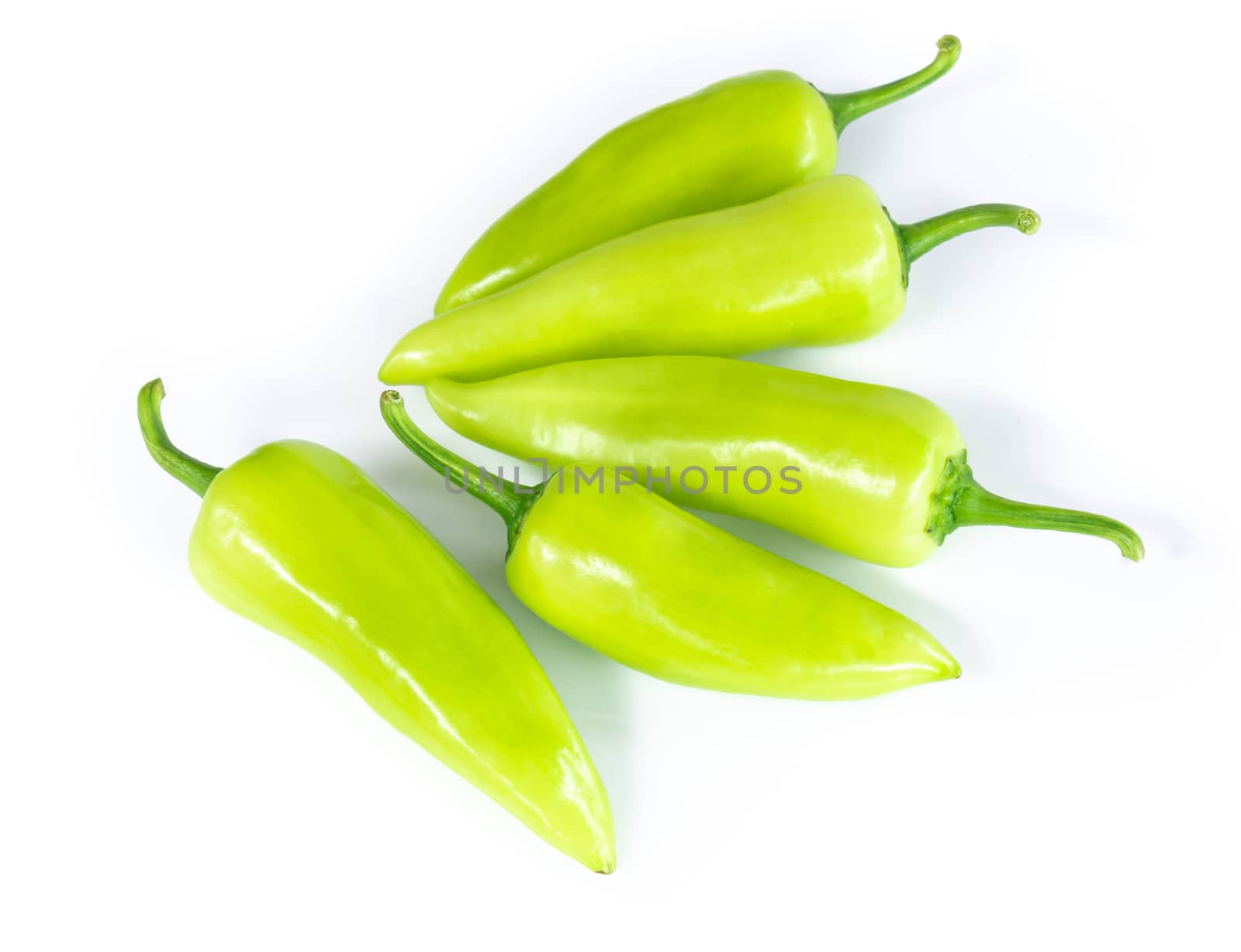 Closeup green chilli pepper on white background, raw food ingredient concept