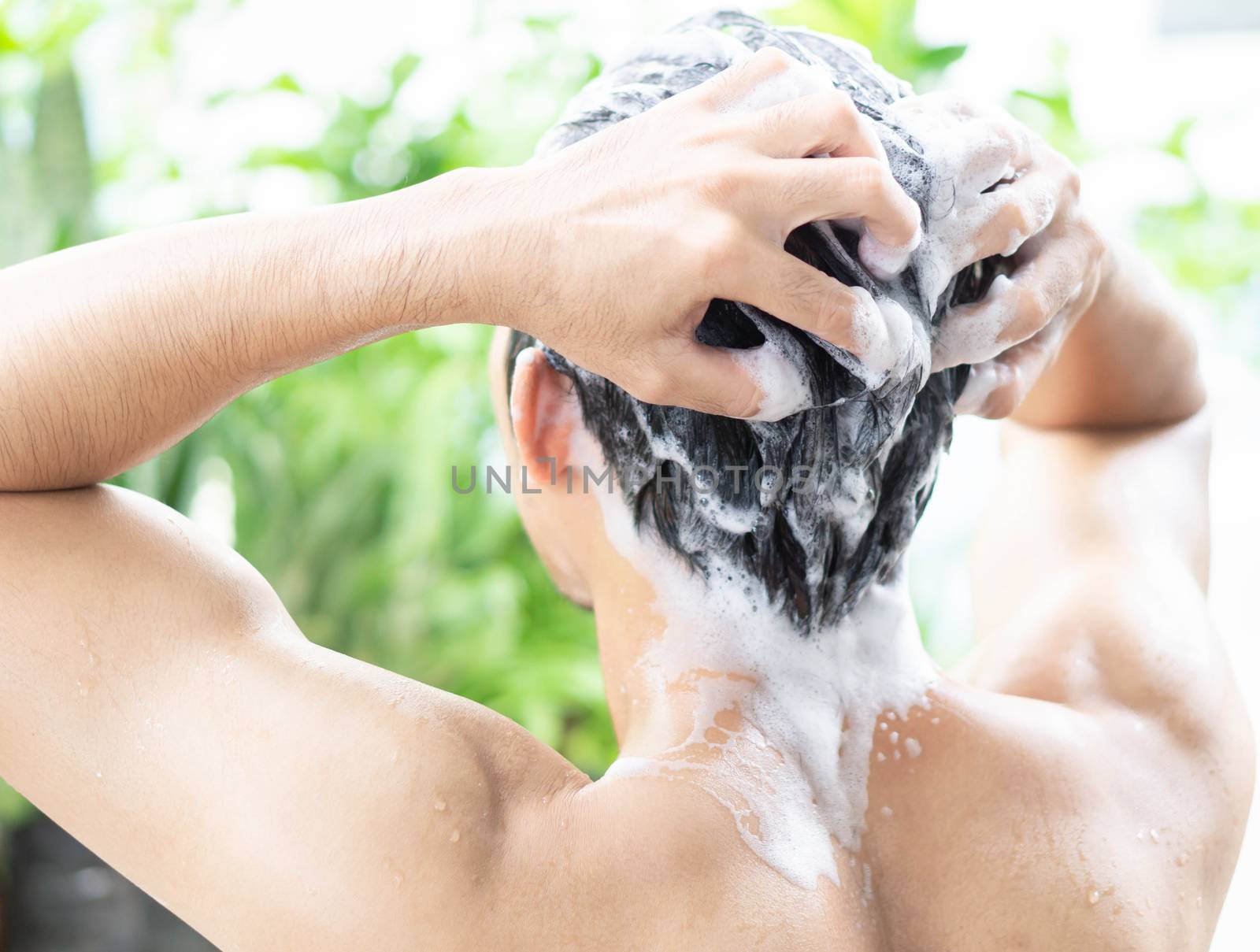 Closeup young man washing hair with shampoo from outdoor, health by pt.pongsak@gmail.com