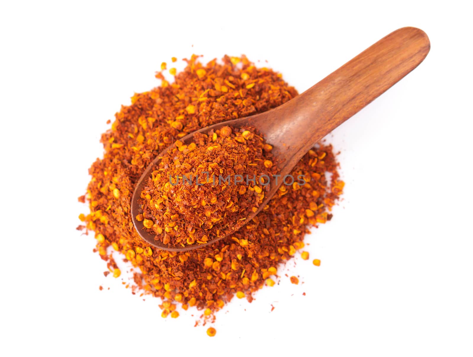 Top view red chilli power in wood spoon on white background, food ingredient