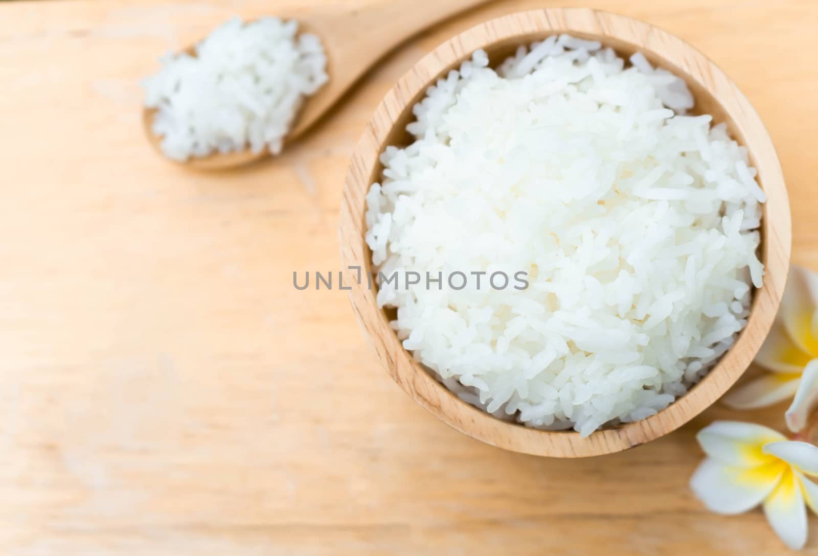 Close up white rice in wooden bowl with spoon, healthy food, selective focus