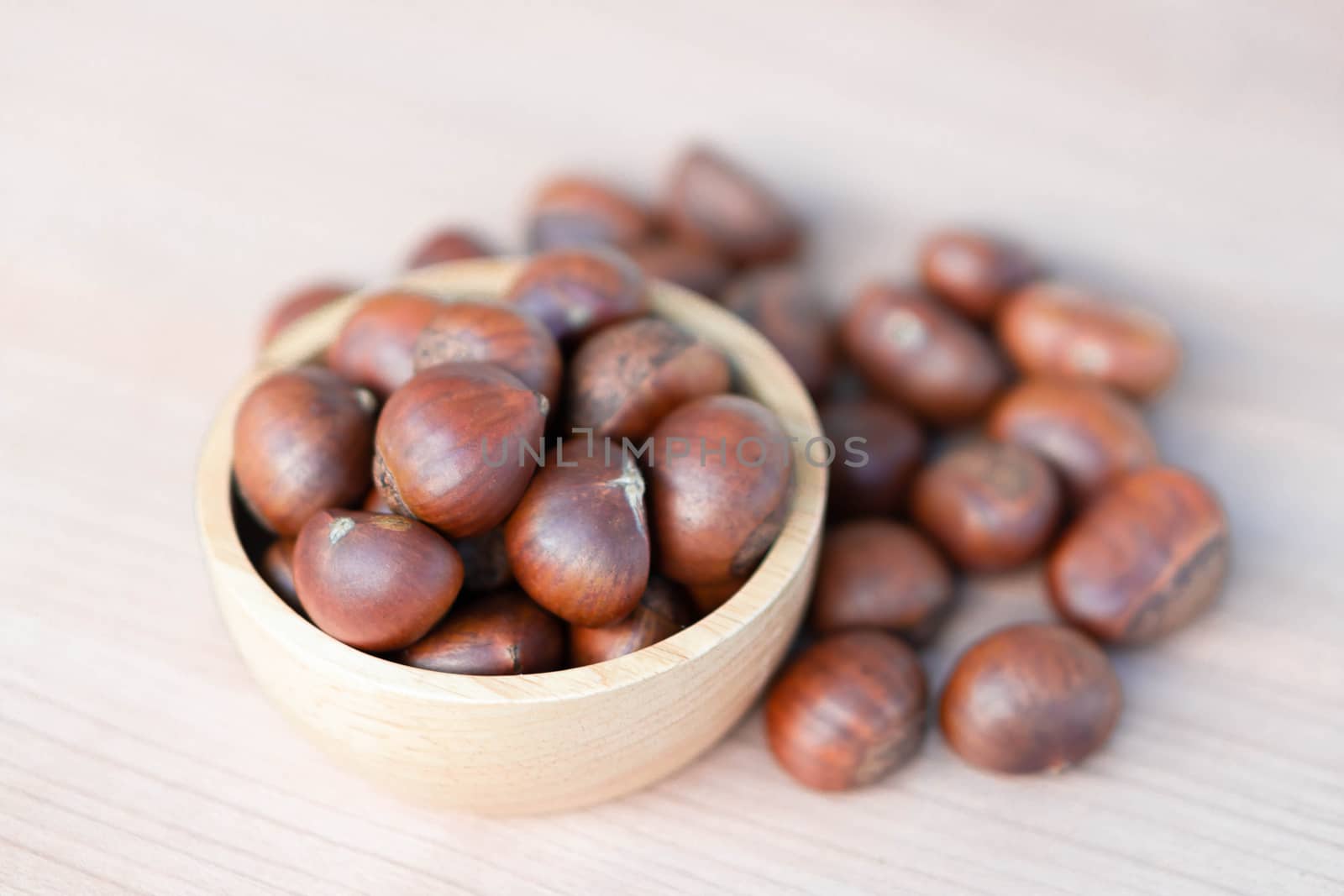 Closeup horse chestnuts in wood bowl isolated on white backgroun by pt.pongsak@gmail.com