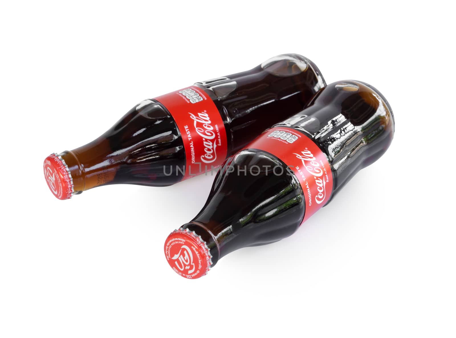 Sakon Nakhon, Thailand - April 21, 2019. Glass bottle of Coca-Cola isolated on white background