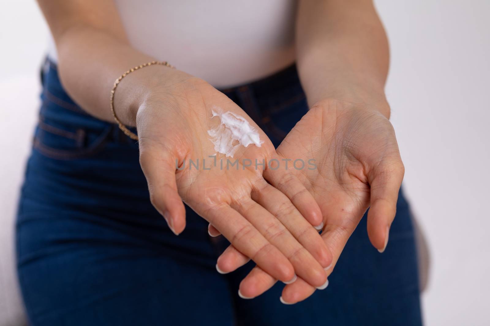 Woman applying hand cream to moisturize skin - stock photo by adamr