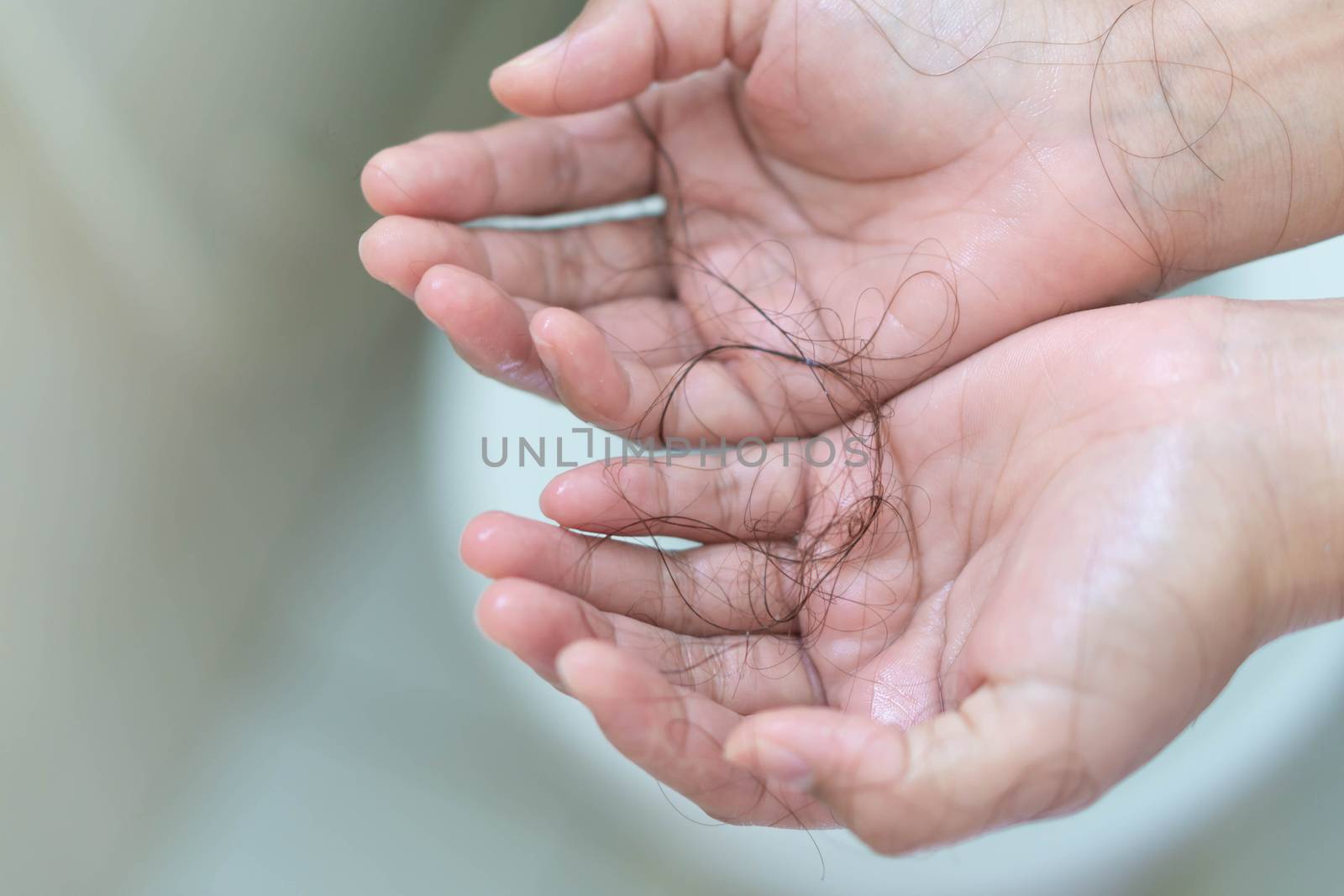 Closeup Hair loss on woman hand in the bathroom