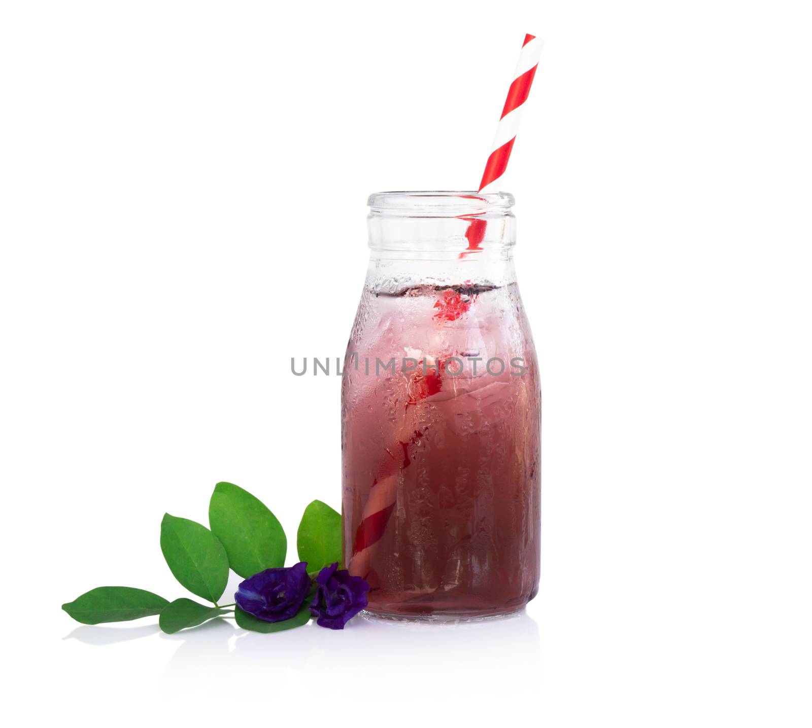 Butterfly pea juce in grass bottle with leaf and flower on white background, herb dink for healthy concept