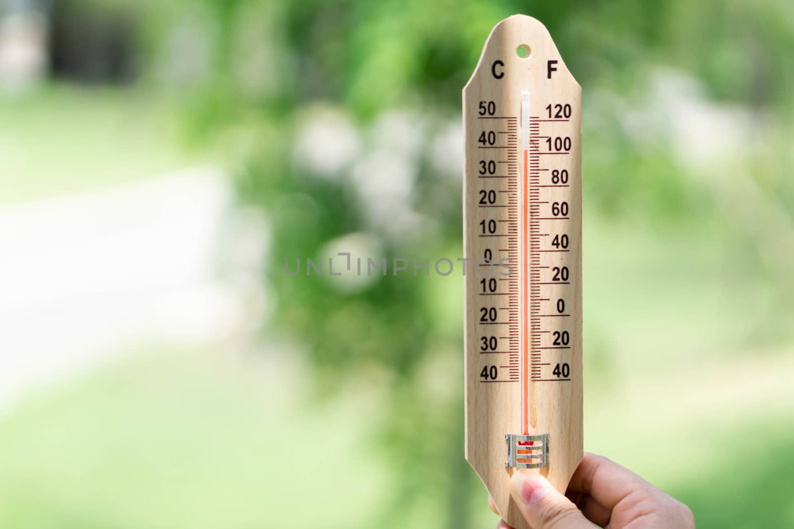 Close up hand holding thermometer with hot temperature  by pt.pongsak@gmail.com