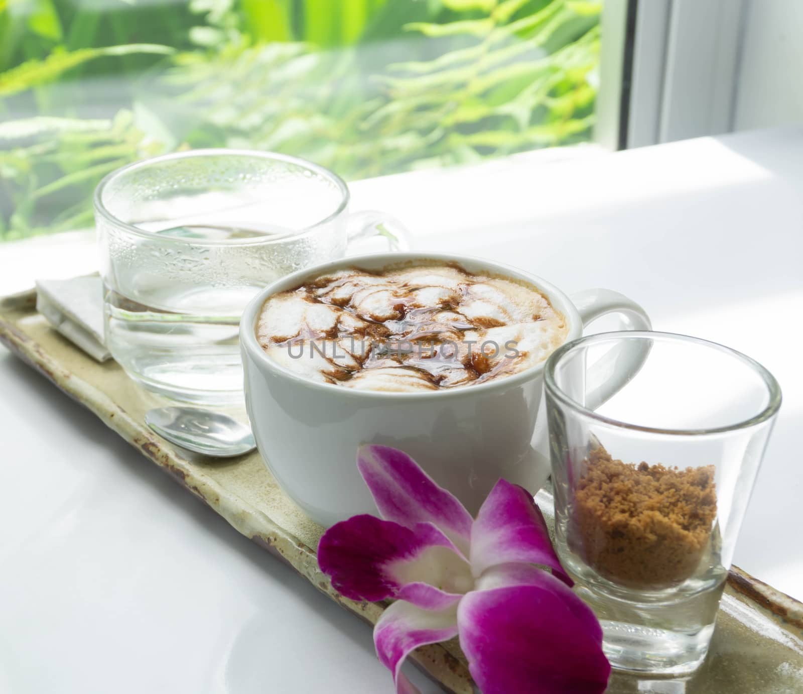 Close up glass of hot coffee with green nature background