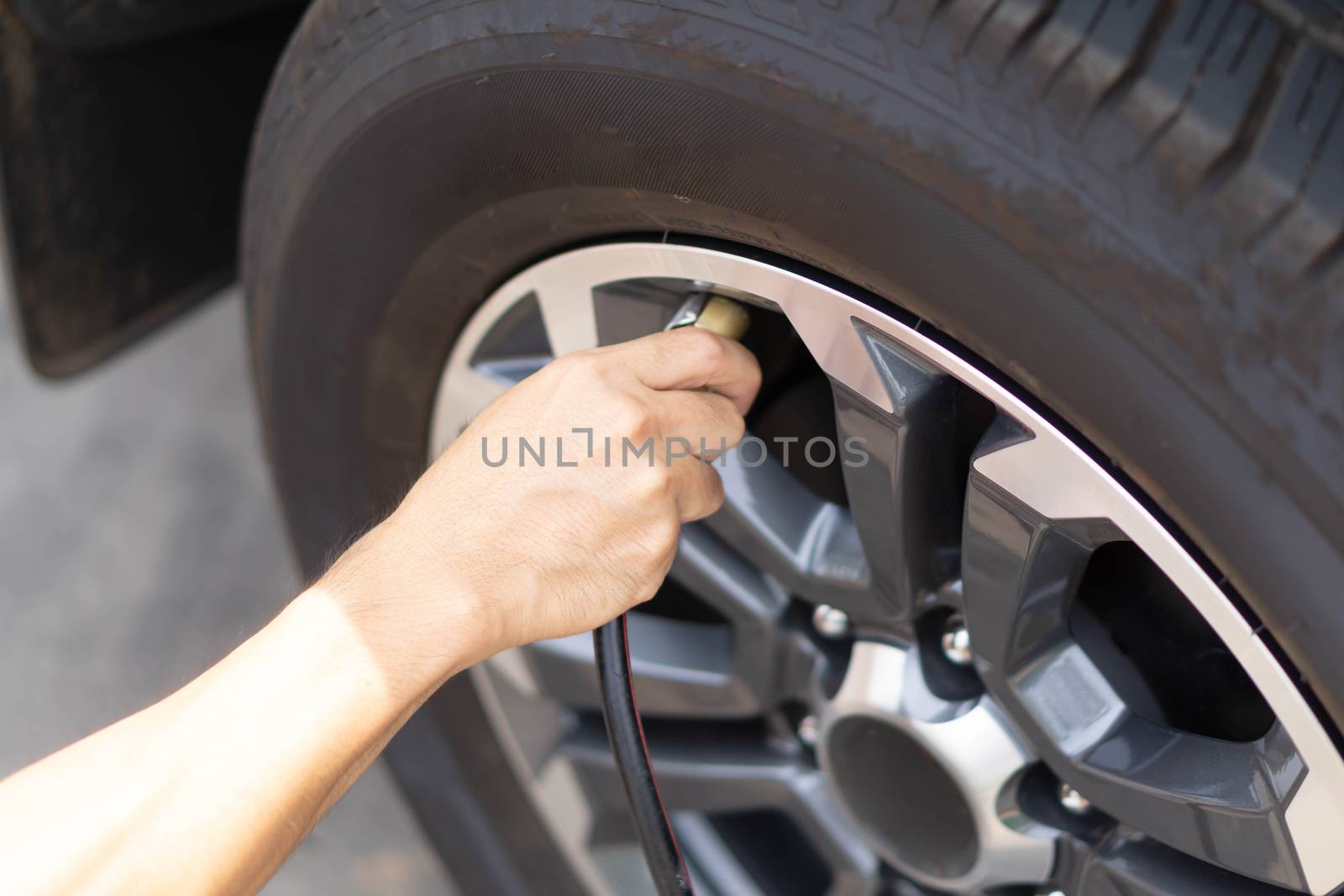 Close up man hand filling wind of the car, selective focus