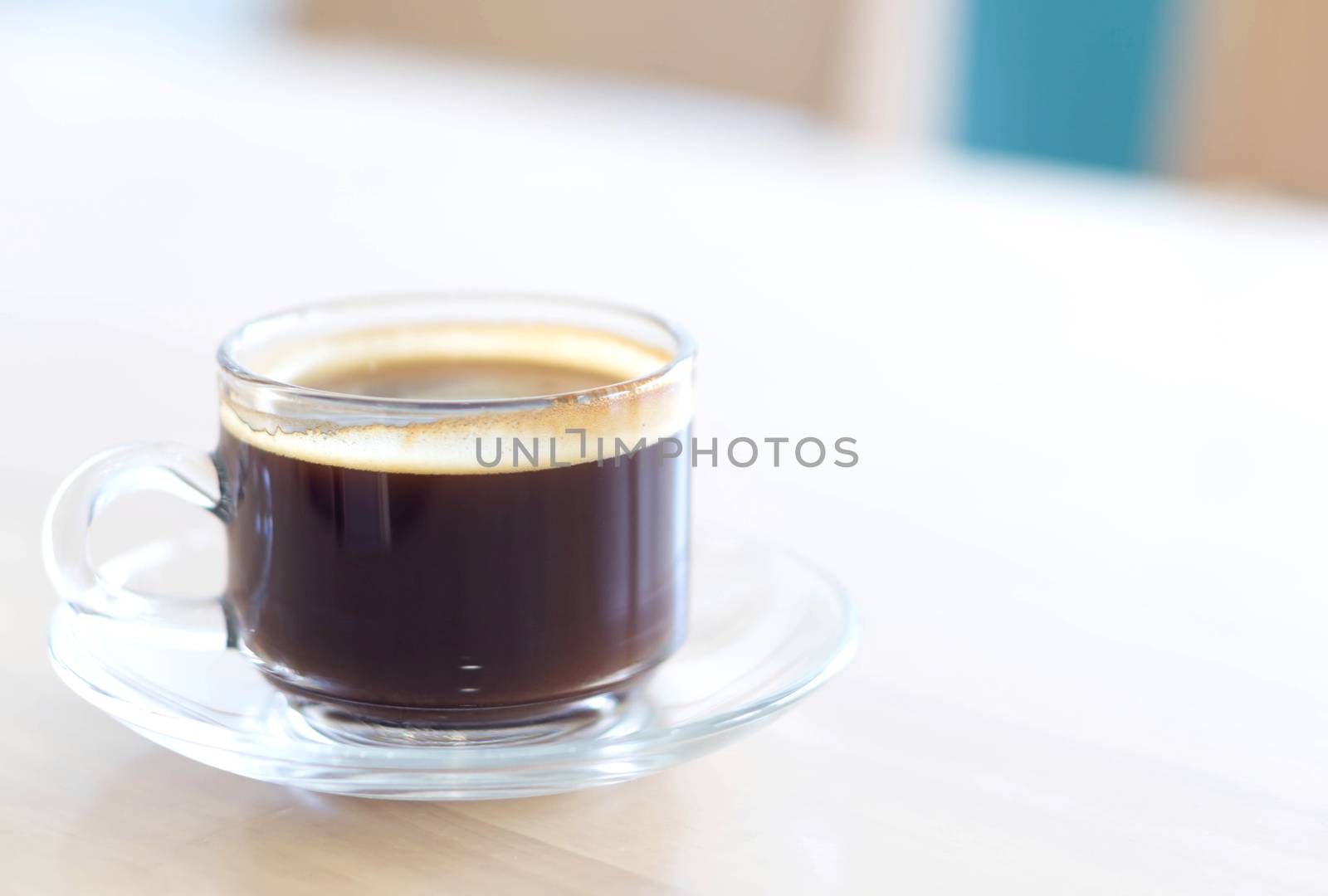 Closeup glass of hot americano coffee on wood table, selective focus, vintage tone
