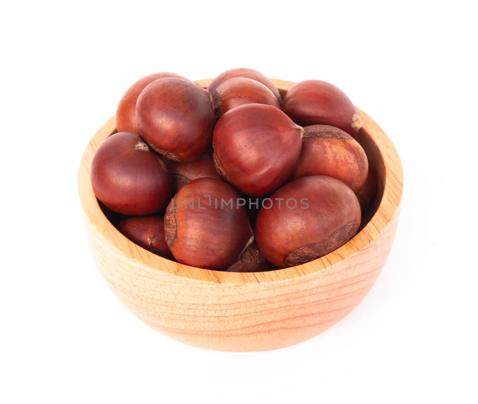 Closeup horse chestnuts in wood bowl isolated on white background,  healthy food concept