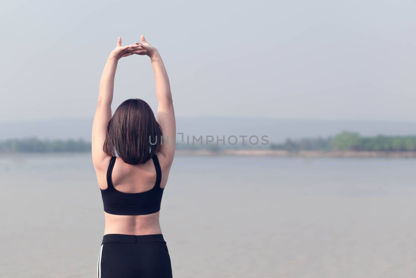 Closeup woman warm up and stretching exercises for running with nature background, vintange tone