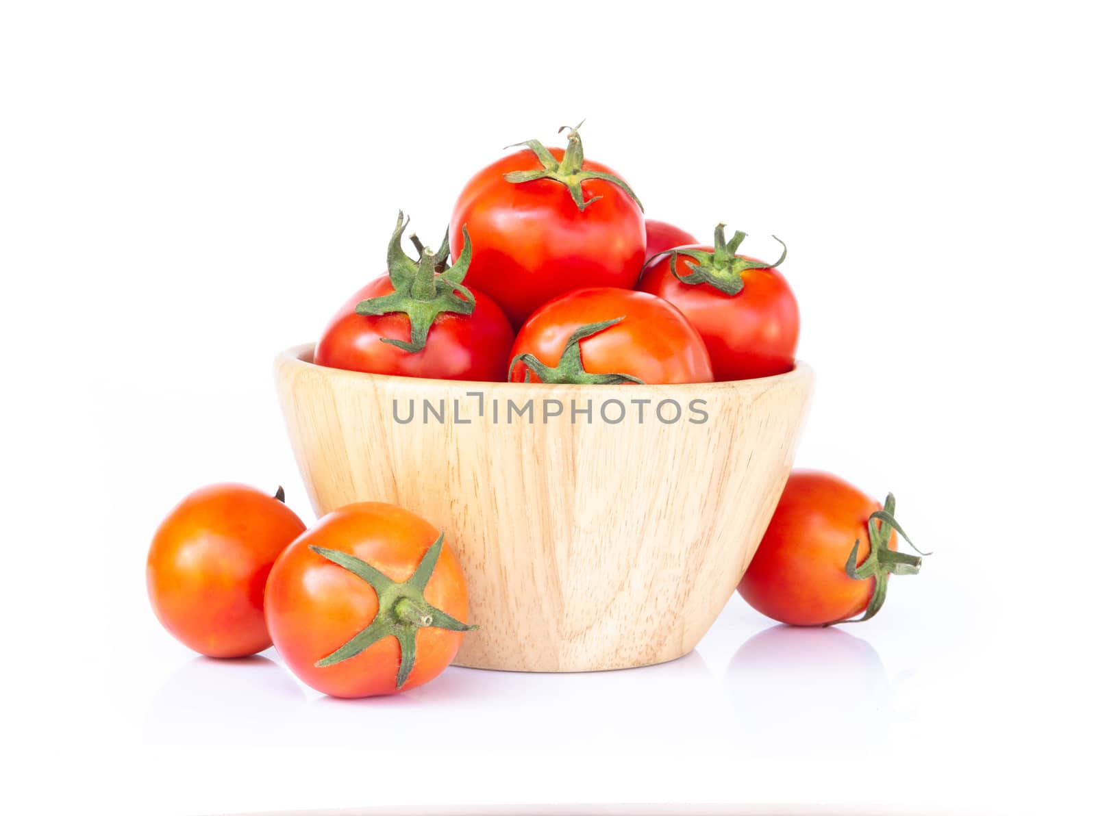 Fresh red cherry tomatoes in wood bowl, selective focus