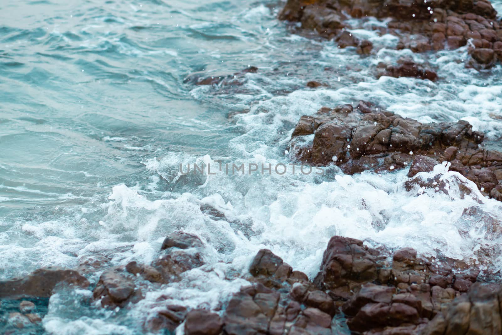 Sea wave breaking with rocky beach, Holiday and relax time concept, selective focus