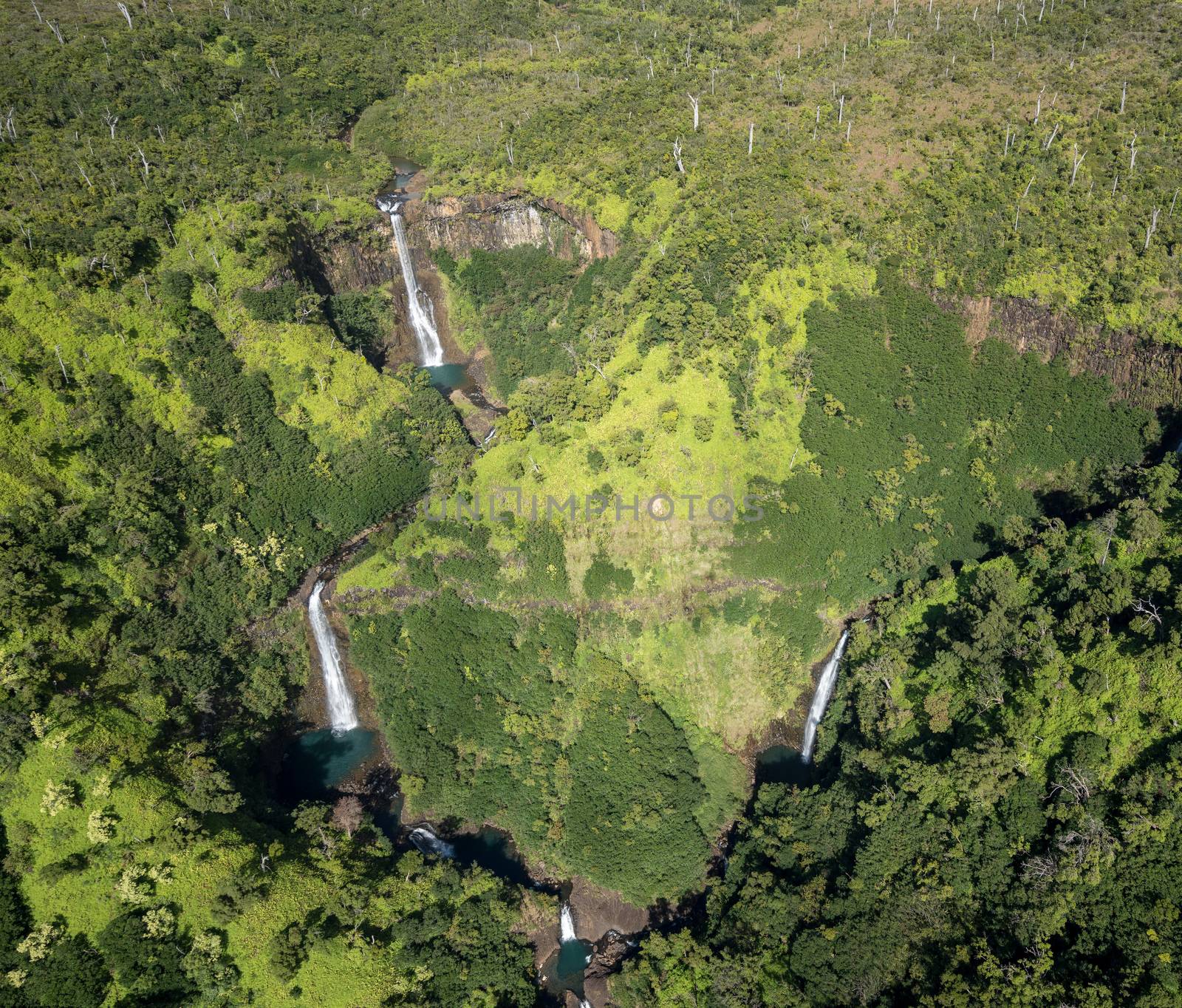 Aerial view of Manawaiopuna Falls and landscape of hawaiian island of Kauai from helicopter flight