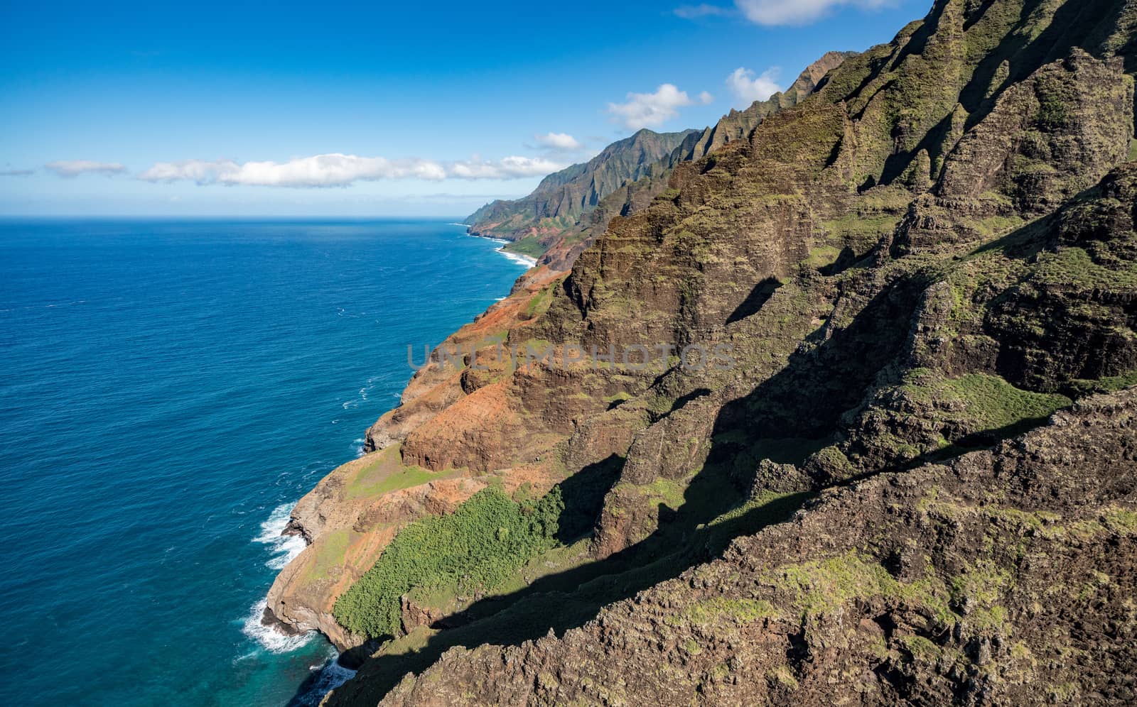Aerial view of Na Pali coastline and landscape of hawaiian island of Kauai from helicopter flight