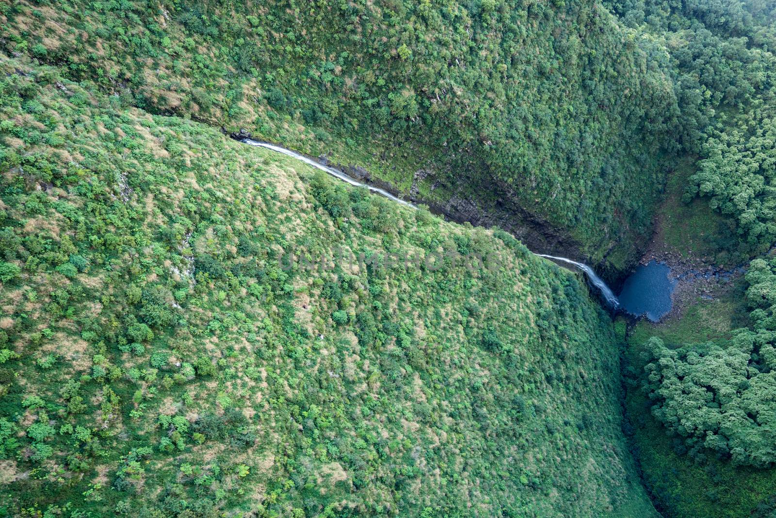Aerial view of Hanakoa Falls on hawaiian island of Kauai from helicopter flight