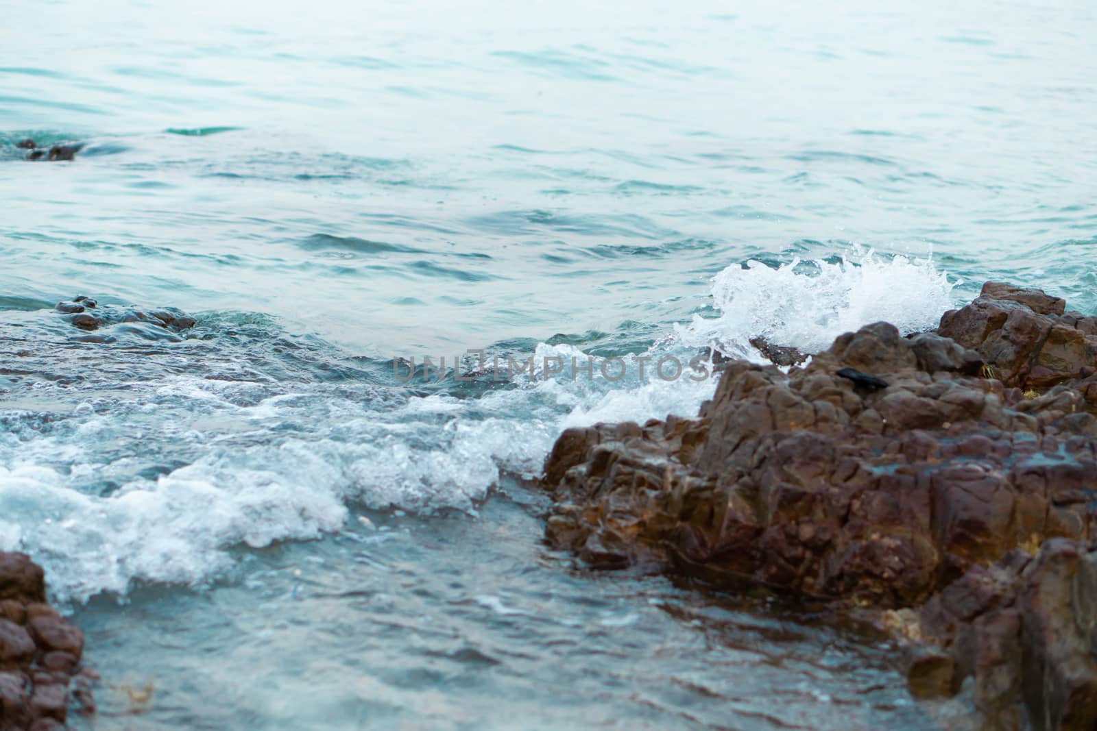 Sea wave breaking with rocky beach, Holiday and relax time concept, selective focus