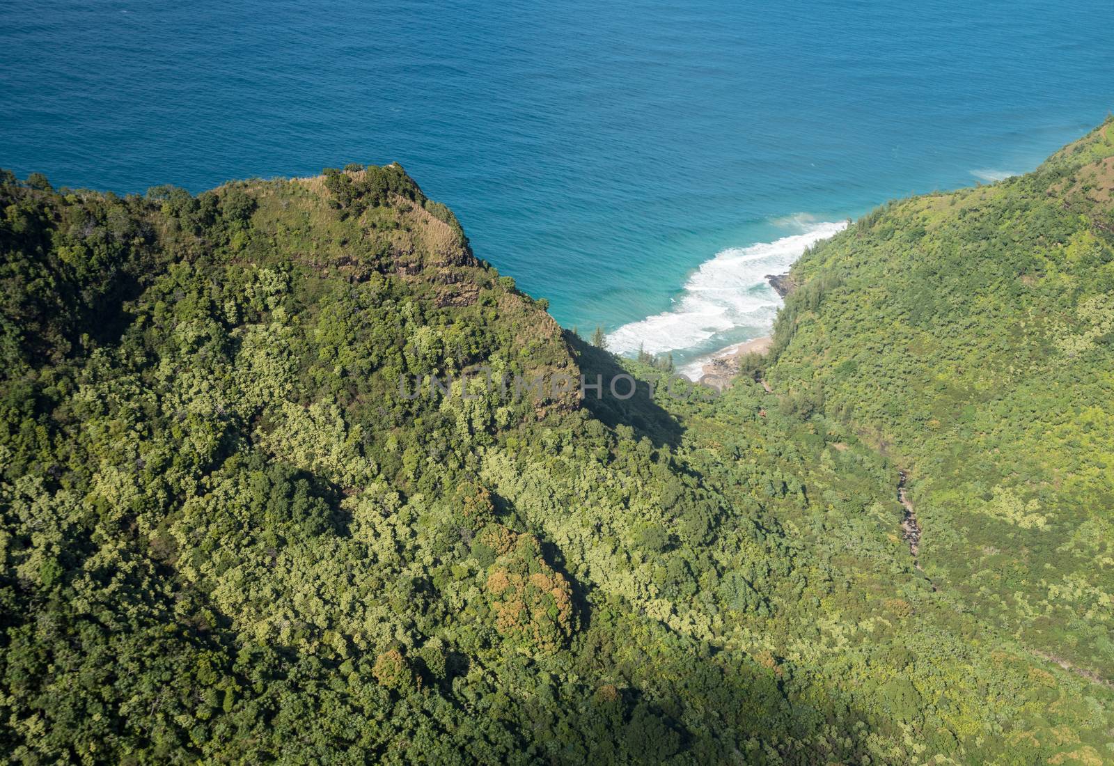 Aerial view of Hanakoa Falls on hawaiian island of Kauai from helicopter flight