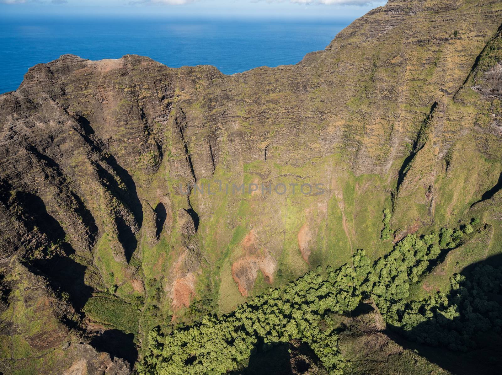 Aerial view of Na Pali coastline and landscape of hawaiian island of Kauai from helicopter flight