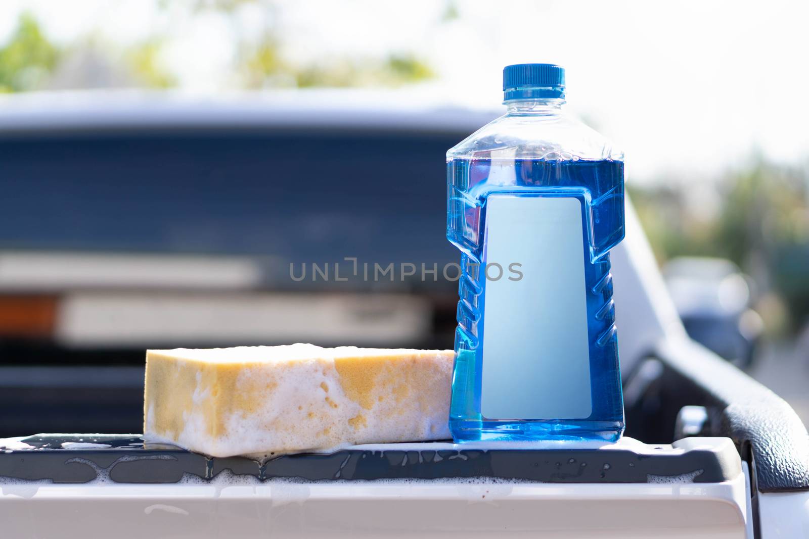 Close up bottle of car wash soap with yellow sponge for washing, by pt.pongsak@gmail.com
