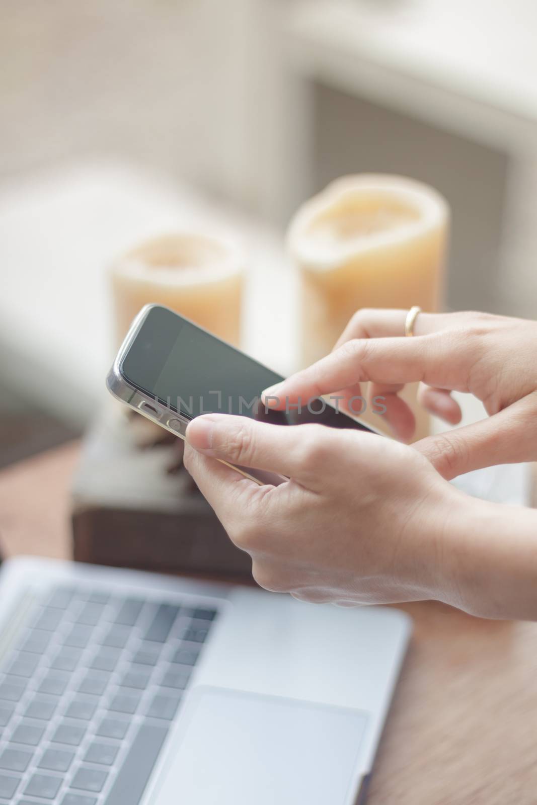 Woman using smart phone in coffee shop, stock photo