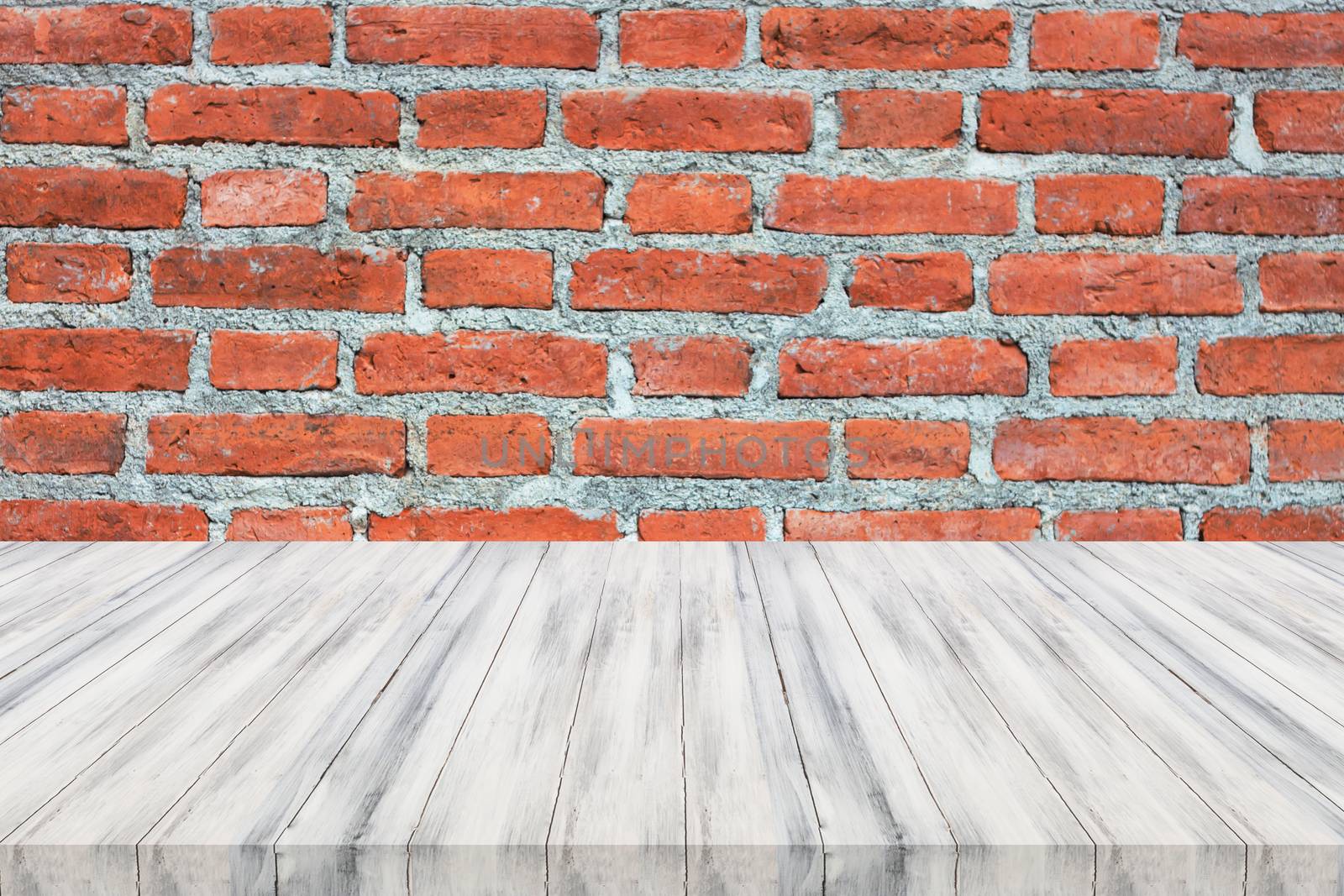 White wooden table top on brick wall by punsayaporn