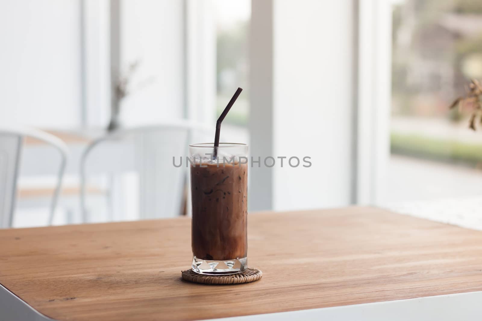 Ice coffee on wooden table by punsayaporn