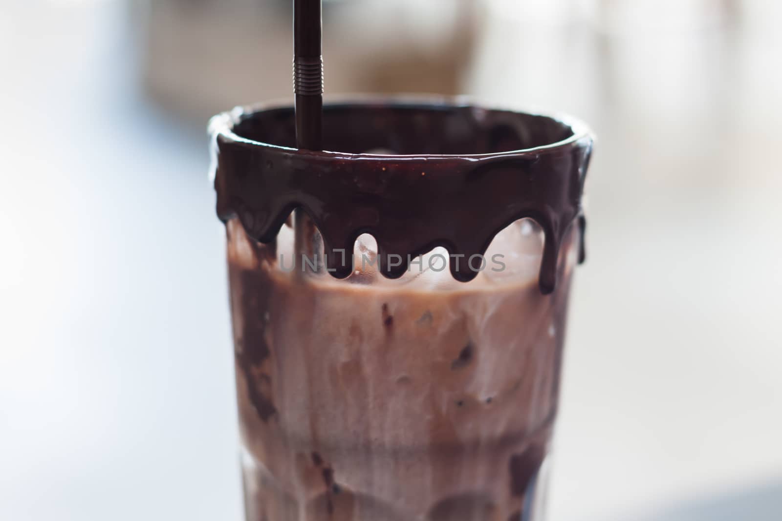 Ice coffee on wooden table by punsayaporn