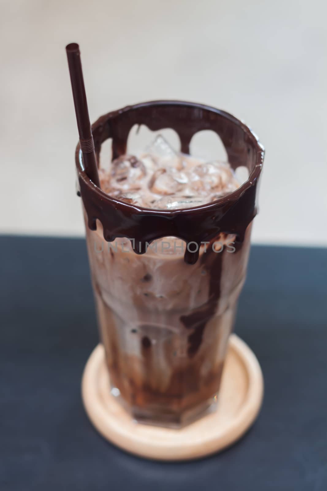 Ice coffee on wooden table by punsayaporn