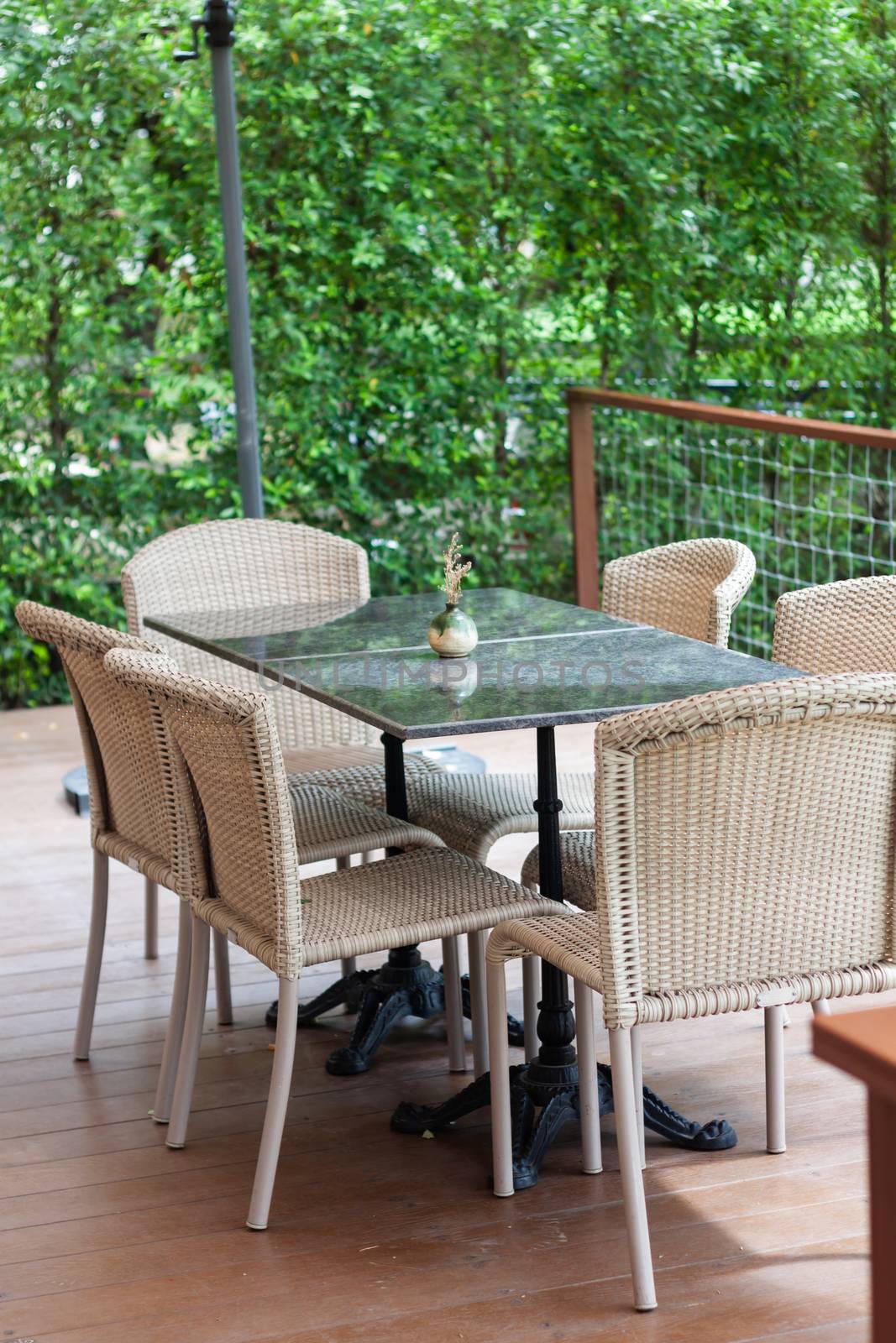 Table and chairs in coffee shop by punsayaporn