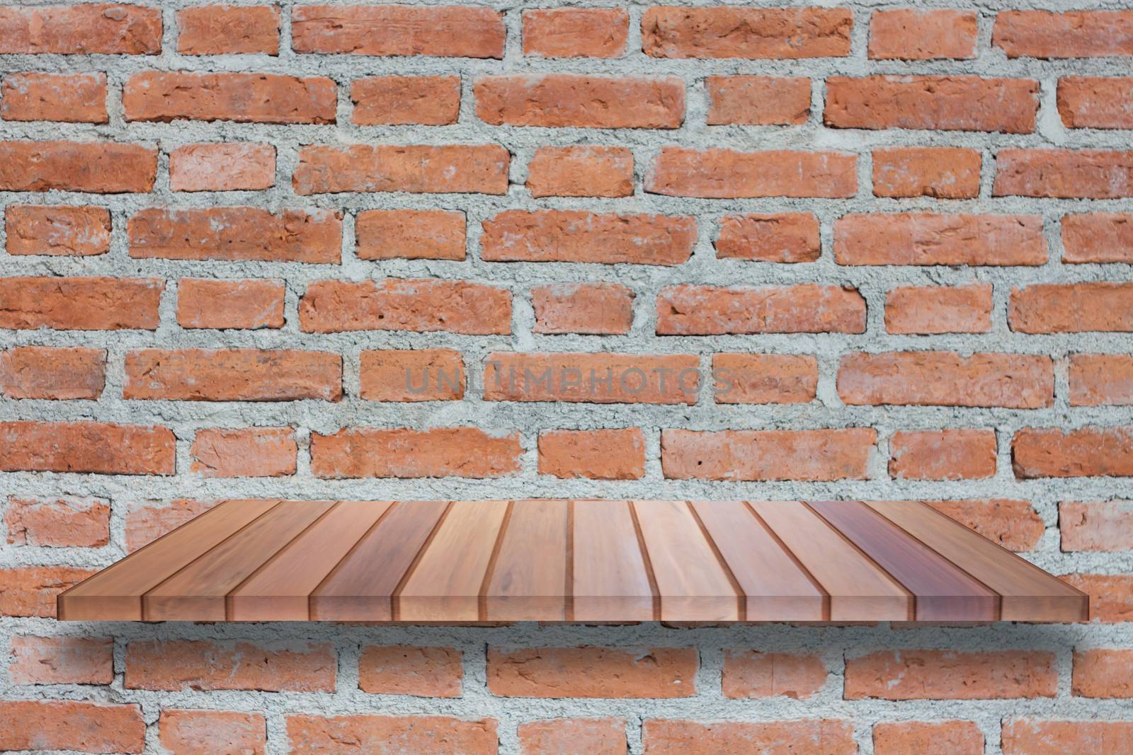 Brown wooden shelf on brick wall by punsayaporn