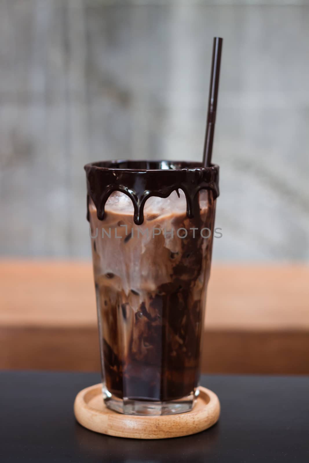 Ice coffee on wooden table by punsayaporn