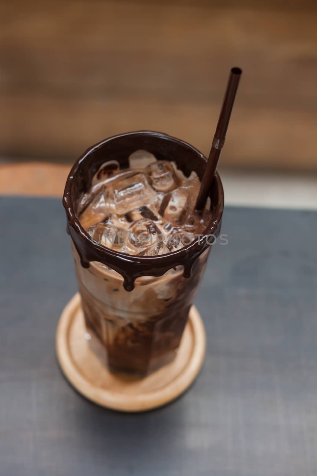 Ice coffee on wooden table by punsayaporn