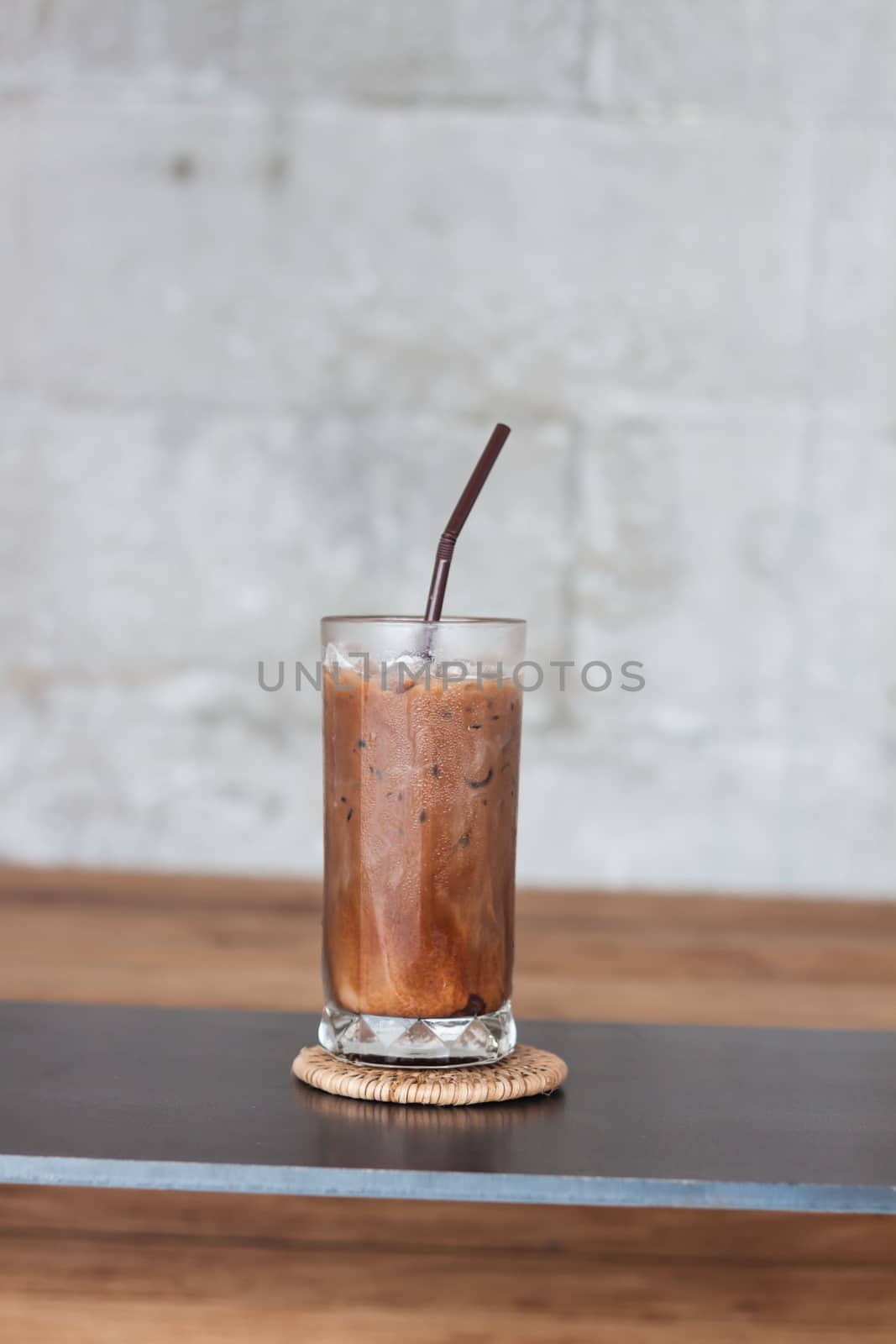 Ice coffee on wooden table by punsayaporn
