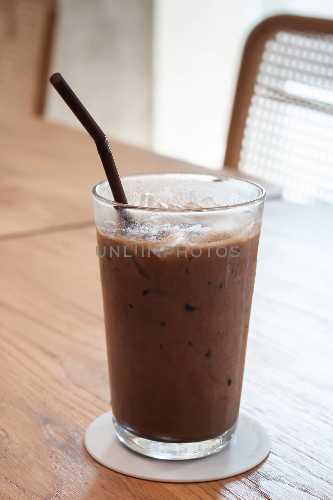 Iced coffee in coffee shop on wooden table, stock photo