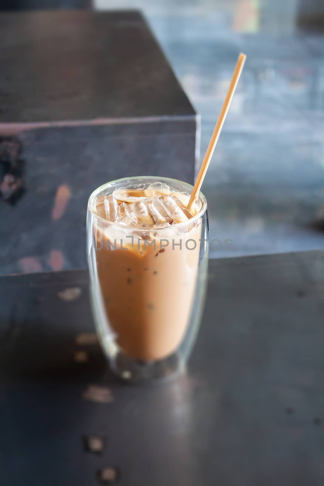 Iced coffee in coffee shop on wooden table, stock photo